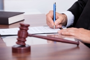 Legal books sit open on a desk, with the scales of justice and a gavel, discussing California Family Code 218