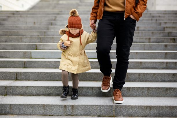 Father holding child's hand